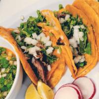 Birria Tacos · 3 Corn tortillas filled with cheese and topped with Goat meat, cilantro and onions. Served w...