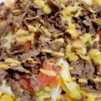 King Nachos · Your choice of steak, ground beef or chicken with jalapenos, shredded lettuce, diced tomato,...