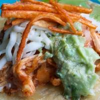 Chicken Tinga · Shredded chicken casserole in chipotle sauce, guacamole, cheese, fried tortilla strips.