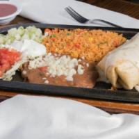 Chimichanga  · Flour tortilla filled with your of meat, deep fried and topped with cheese sauce. Served wit...