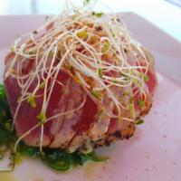 Tuna Tataki · Marinated seared red tuna served over seaweed salad, honey wasabi, and sprouts.

*Consuming ...