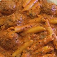 Rigatoni Veronese · Sautéed mushrooms, meatballs and sausage with alla panna sauce over ziti pasta.