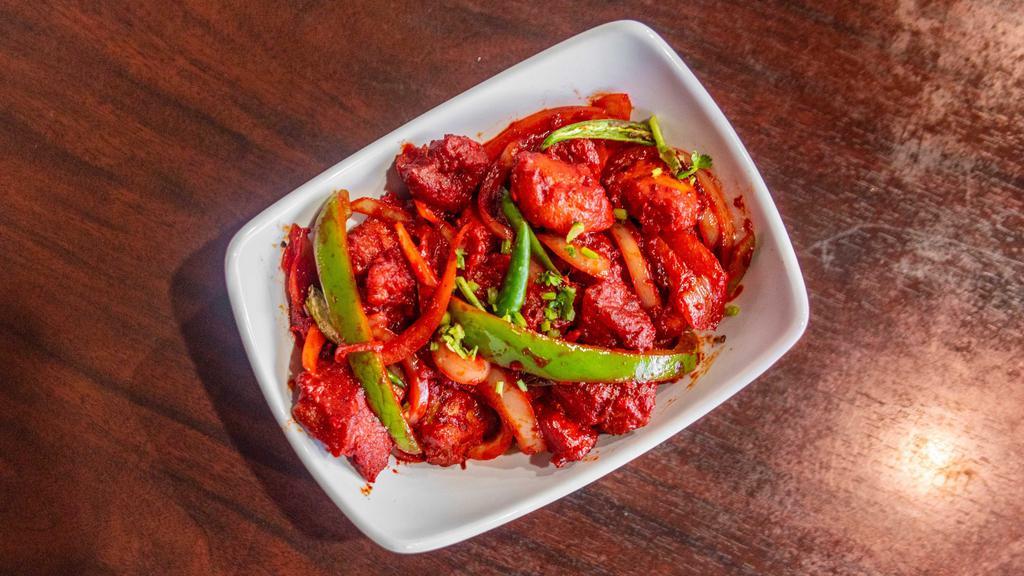 In18. Chicken 65 · Boneless chicken pieces marinated in Indian spices served with house sauce.