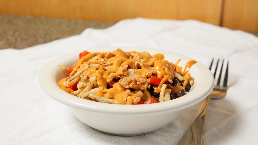 Southwest Bowl · Vegetarian. Roasted red pepper, black beans, corn, onion straws, topped with a spicy chipotle sauce, served on a bed of fresh quinoa.
