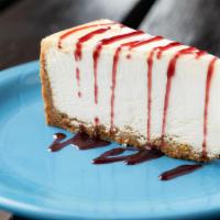 Original Ny Cheesecake · Deliciously decadent cheesecake drizzled with your choice of caramel, raspberry or chocolate.