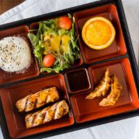 Salmon Teriyaki Bento Box · Combination lunch box served with miso, salad, rice, fruit and gyoza.