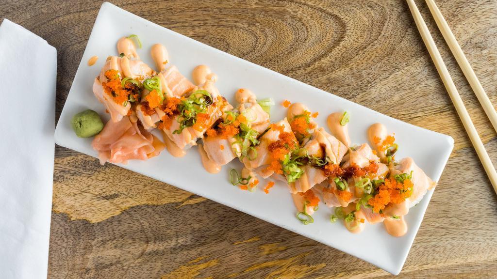 Naughty Girl Roll · Tempura shrimp, avocado and cream cheese topped with baked salmon spicy mayo, sweet sauce, masago and scallions.