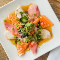 Sashimi Carpaccio · salmon, white tuna, yellowtail, tomatoes, jalapenos, cilantro, lemon, tobiko, truffle oil an...