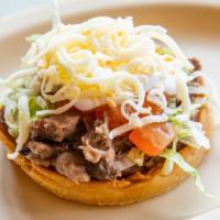 Pastor Sopes · Marinated pork. Lettuce, tomato, sour cream, cheese, beans and hot sauce.