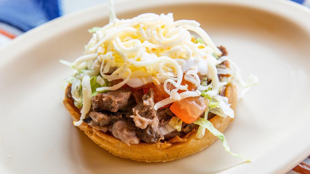 Chorizo Sopes · Mexican Sausage. Lettuce, tomato, sour cream, cheese, beans and hot sauce.