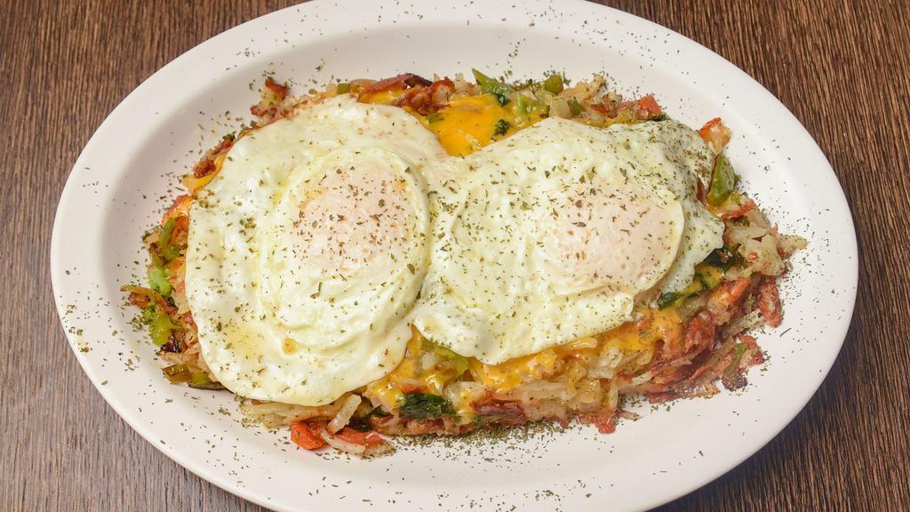 Veggie Hash · Sautéed spinach, broccoli, peppers, onions, tomato, and asparagus, atop a bed of crispy hash browns, loaded with Cheddar cheese topped with two eggs over easy. *Consuming raw or undercooked meats, poultry, seafood or eggs may increase your risk of foodborne illness.