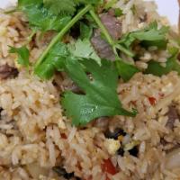 House Fried Rice · With eggs, scallions and onions garnished with cilantro.
