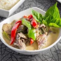 Green Curry · Green curry paste & coconut milk prepared with bell peppers, eggplant, & fresh basil.