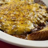 Chili Cheese Steak (5 Oz) · Served in a platter of chili.