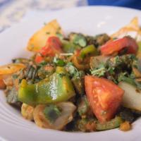 Okra Masala · Cut okra pan cooked with chopped onions, tomatoes, spices and herbs.