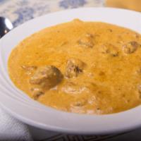 Lamb Koorma · Boneless pieces of lamb cooked in a blend of yogurt, nuts and spices.