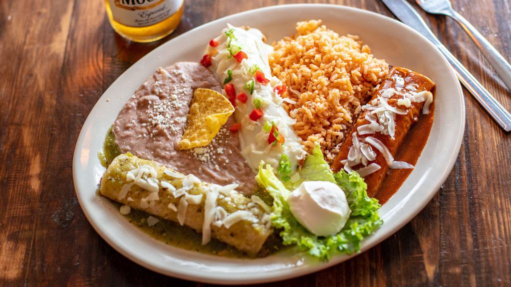 Enchiladas Plate · Shredded beef, ground beef, chicken or cheese.  Suizas with a mild red pepper sauce, verdes with a tomatillo sauce or with our homemade mole.