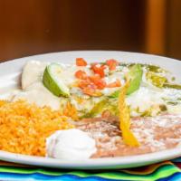 Seafood Enchiladas · Served with fish and shrimp, mango sauce on the side.