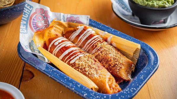 Tamales Nortenos (2) · Two corn husk stuffed with shredded chicken in guajillo sauce served with cream and cheese.