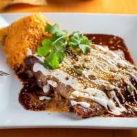 Enmoladas · Three rolled corn tortillas stuffed with Chicken, doused with our most famous red Mole sauce...