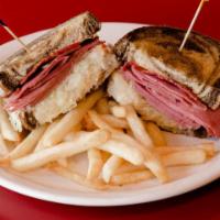 Reuben · The deli classic. Thin-sliced corned beef grilled and topped with sauerkraut, thousand Islan...