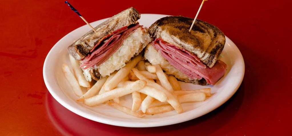 Reuben · The deli classic. Thin-sliced corned beef grilled and topped with sauerkraut, thousand Island dressing and Swiss cheese on grilled marble rye bread.
