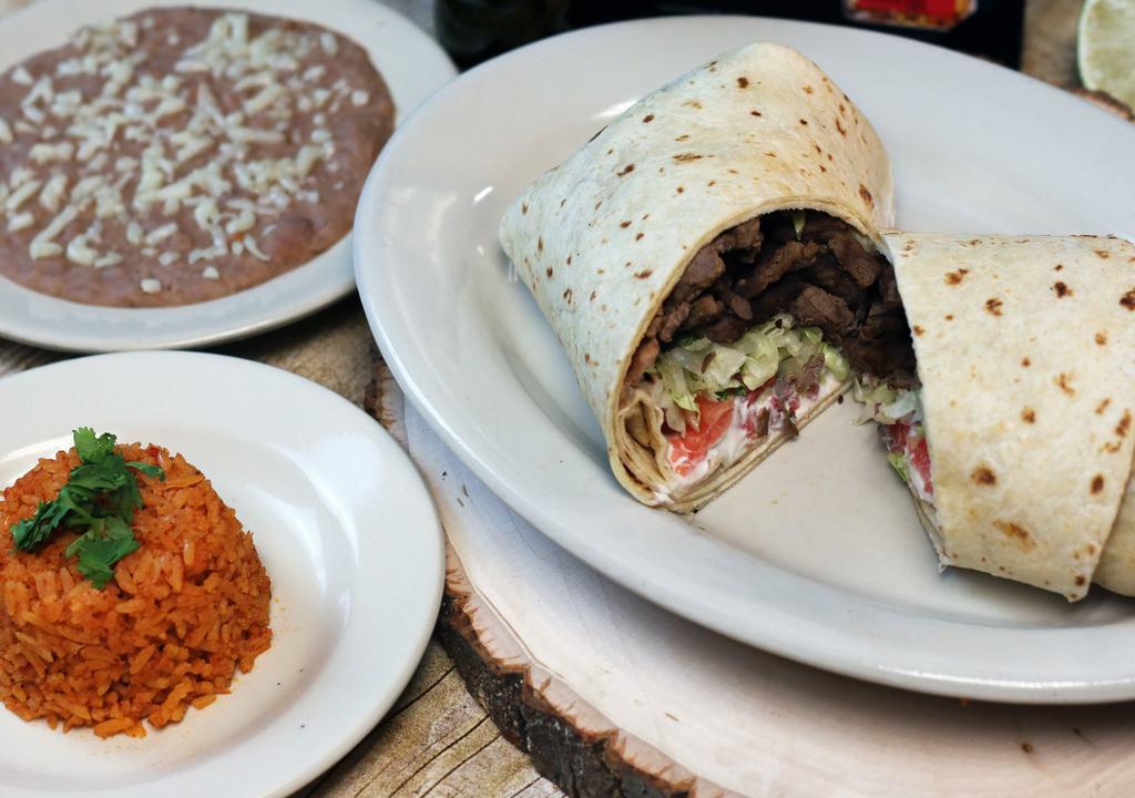 Big Burrito · Choice of ground beef, chunky beef, chicken or pork. Served rice & beans.