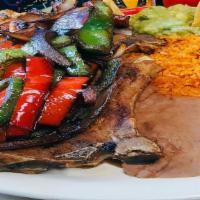 Pork Chops · Topped with grilled onions, tomatoes & green bell peppers with choice of fries or rice & bea...