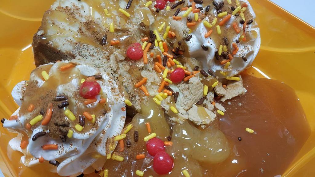 Caramel Candy Apple Pie Cheesecake Sundae · Cheesecake with whipped cream topping, apple pie filling, caramel sauce, graham cracker, cinnamon red hots, cinnamon sugar and fall sprinkles