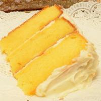 Lemon Cake Slice · Lemon Cake with a lemon curd in between each layer topped with our lemon cream cheese icing!