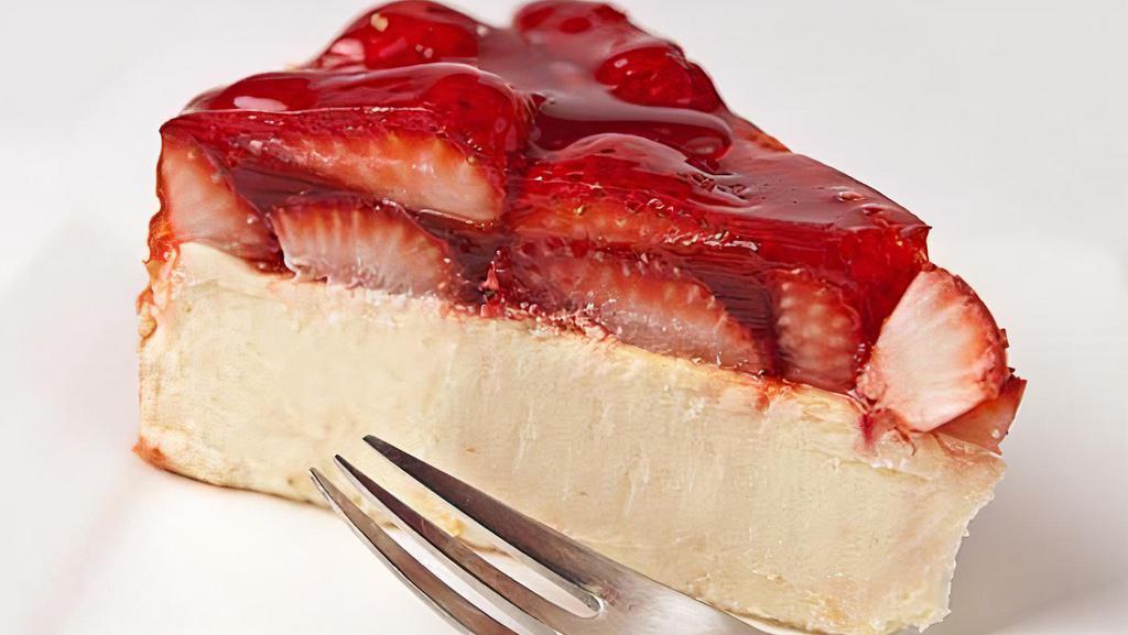 Colossal Strawberry Cheesecake · Rich and creamy cheesecake covered with strawberries