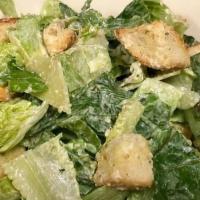 Caesar Salad · romaine lettuce, parmesan cheese, and croutons all tossed with a creamy caesar dressing.
