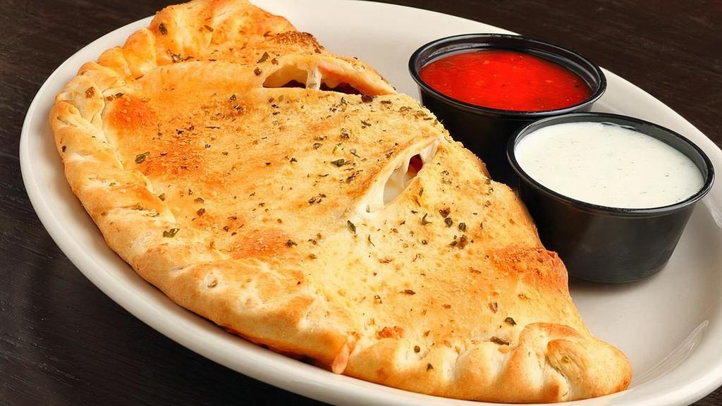 Calzone · Pizza dough topped with marinara sauce, mozzarella cheese, and your favorite pizza toppings, wrapped into a calzone.  Served with a side of marinara and Georgio's ranch dressing!