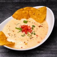 Cheese Dip W/ Chips · Our homemade signature cheese sauce