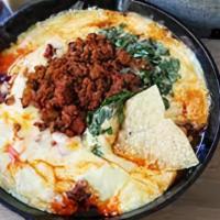 Queso Fundido · Melted cheese mixed with your choice of chorizo, steak, ground beef, pastor, chicken or vegg...