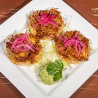 Panuchos · 3 slowly toasted tortillas, stacked with refried beans, cochinita pibil (pulled pork yucatan...
