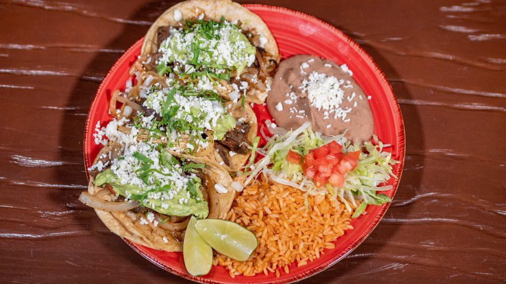 Del Norte Taco · 3 charbroiled skirt steak tacos topped with gaucamole, cilantro, grilled onion and queso fresco, served with rice and beans