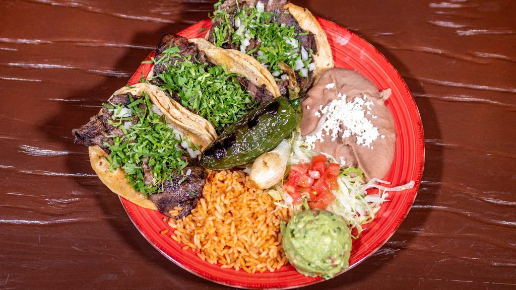 Lomo Taco Dinner · 3 thin cut rib-eye tacos served with a side of gaucamole, grilled jalapenos and grilled onion, served with rice and beans