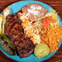 Tampiquena · Charbroiled seasoned skirt steak with red enchilada topped with cheese, served with guacamol...
