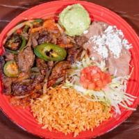 Bistek A La Mexicana · Rib-eye with grilled jalapeno, onion, tomato and cilantro, served with rice beans and tortil...