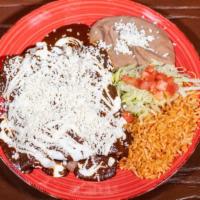 Enchiladas De Mole · 3 enchiladas topped with our signature mole sauce, melted cheese, sour cream and filled with...