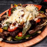 Super Fajitas - Steak · Sizzling platter of caramelized onions, mixed bell peppers, choice of meat, topped with melt...