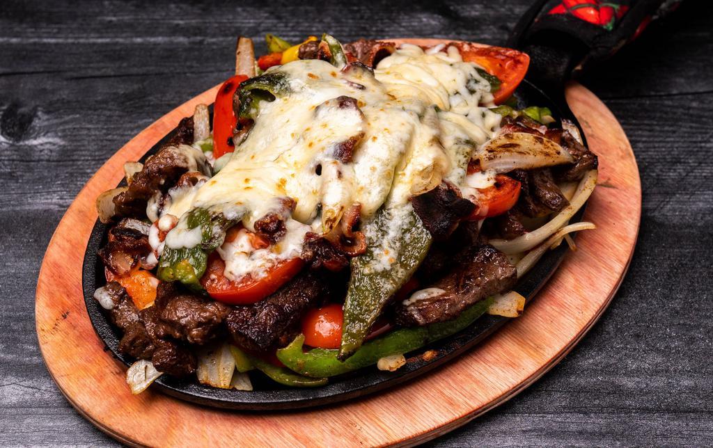 Super Fajitas - Steak · Sizzling platter of caramelized onions, mixed bell peppers, choice of meat, topped with melted chihuahua cheese and crispy bacon