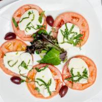 Caprese Salad · Fresh tomato slices topped with fresh mozzarella, fresh
basil, olives, and olive oil