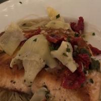 Salmone Pulcinella · Pan seared salmon filet with sauteed
artichokes, capers, and sun-dried tomatoes
in a white w...