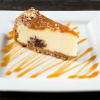 Caramel Turtle Cheesecake · Delightful cheesecake with chocolate fudge center topped with caramel and toasted pecans.