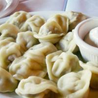 Siberian Pelmeny · Siberian recipe dumplings filled with chicken and onions, topped with melted butter, served ...