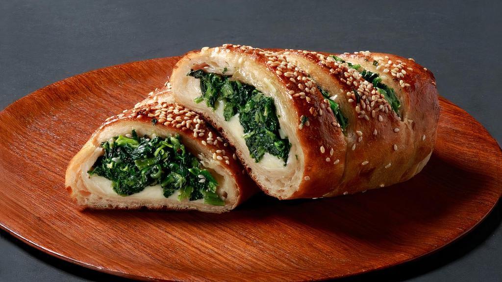 Spinach Stromboli · Spinach, Ricotta, freshly shredded 100% whole milk mozzarella and Romano cheese rolled in hand-stretched dough and baked to perfection, then topped with sesame seeds..