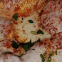 Stuffed Shells · Large Ricotta Mixture Cheese filled Shells topped with our Homemade Meat sauce, and baked to...