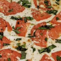Margherita Pizza · Olive Oil, Fresh Tomato Slices, Fresh Mozzarella and Fresh Basil.